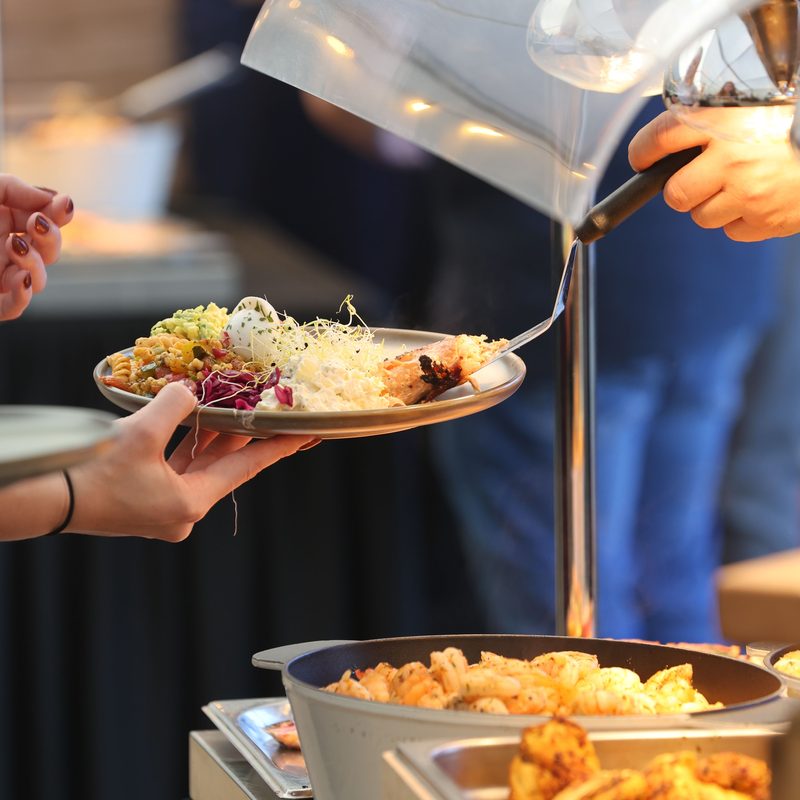 Guests serving themselves at a catered buffet